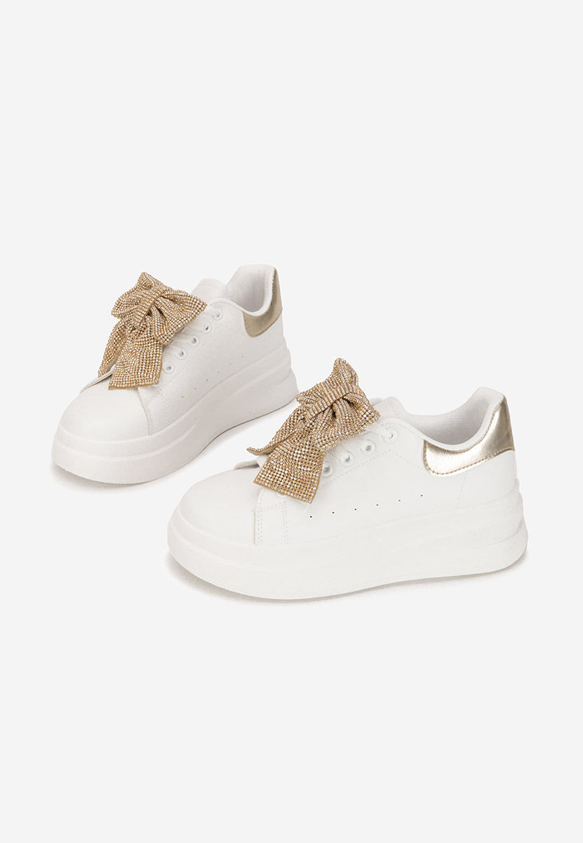 Złote sneakersy na platformie Anitta
